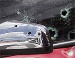 Marcas de tiros no retrovisor do Astra usado pela vtima
