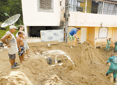 Habitantes de Angra dos Reis observam escavao<br> para retirar carro soterrado em condomnio