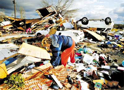 Vtimas vasculham destroos causados por tornados no Mississippi, nos EUA, na noite de tera e ontem; resultado de uma forte frente fria