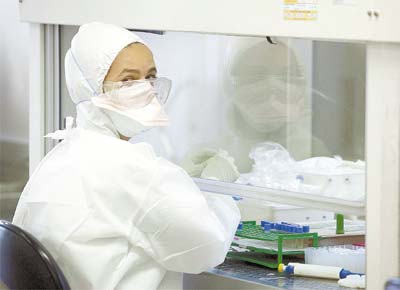 Funcionria do Instituto Adolfo Lutz, em So Paulo, manipula material em laboratrio para o diagnstico do vrus da gripe A (H1N1)