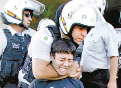 <b>Engravatado:</b> Policial reprime manifestante em ato<br> na frente da Cmara do DF, que fechou as portas