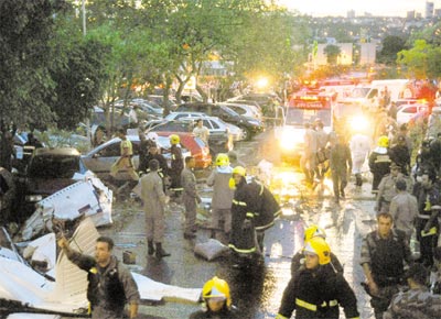 Equipe de resgate trabalha junto aos destroos do monomotor<br>que caiu no estacionamento de um shopping center em Goinia