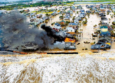 Casa sofre incndio em inundao na cidade de Galveston, no Estado do Texas, pela qual o furaco Ike deveria passar na madrugada de hoje