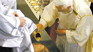O papa Bento 16 lava os ps de um homem em missa