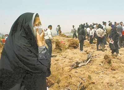 <b>SEM SOBREVIVENTES:</b> Moradores da regio de Qazvin (Ir), a cerca de 200 km de Teer, observam o local onde caiu um avio iraniano