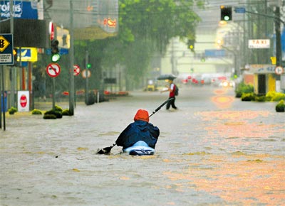 <b>FIM DA TRGUA:</b> Morador de Joinville percorre de caiaque avenida inundada pelas chuvas que voltaram a atingir Santa Catarina