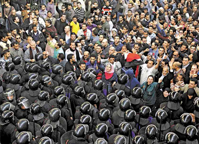 Manifestantes protestam diante de policiais no Cairo (Egito)