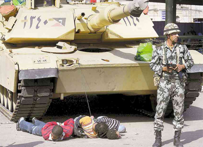 Supostos saqueadores so amarrados por militares a um tanque, no Cairo, onde cidados patrulharam ruas em milcias