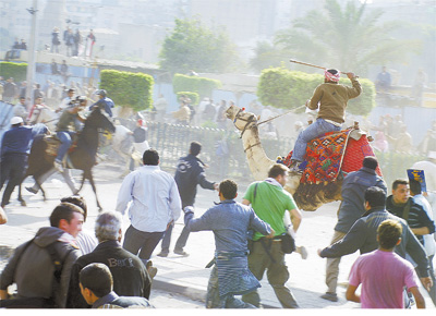 Partidrios do ditador do Egito, Hosni Mubarak, montando camelos e cavalos, entram em choque com manifestantes contrrios